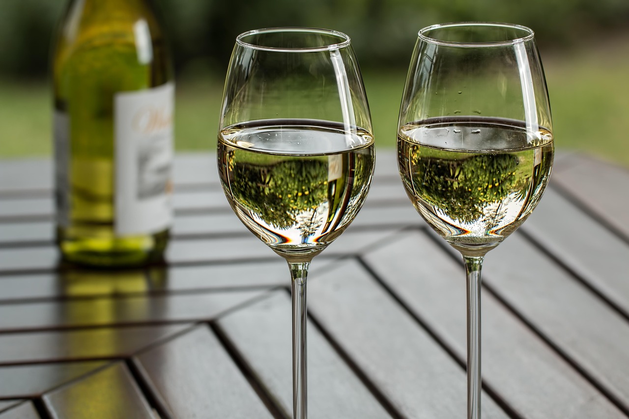 A glass of white wine being tasted