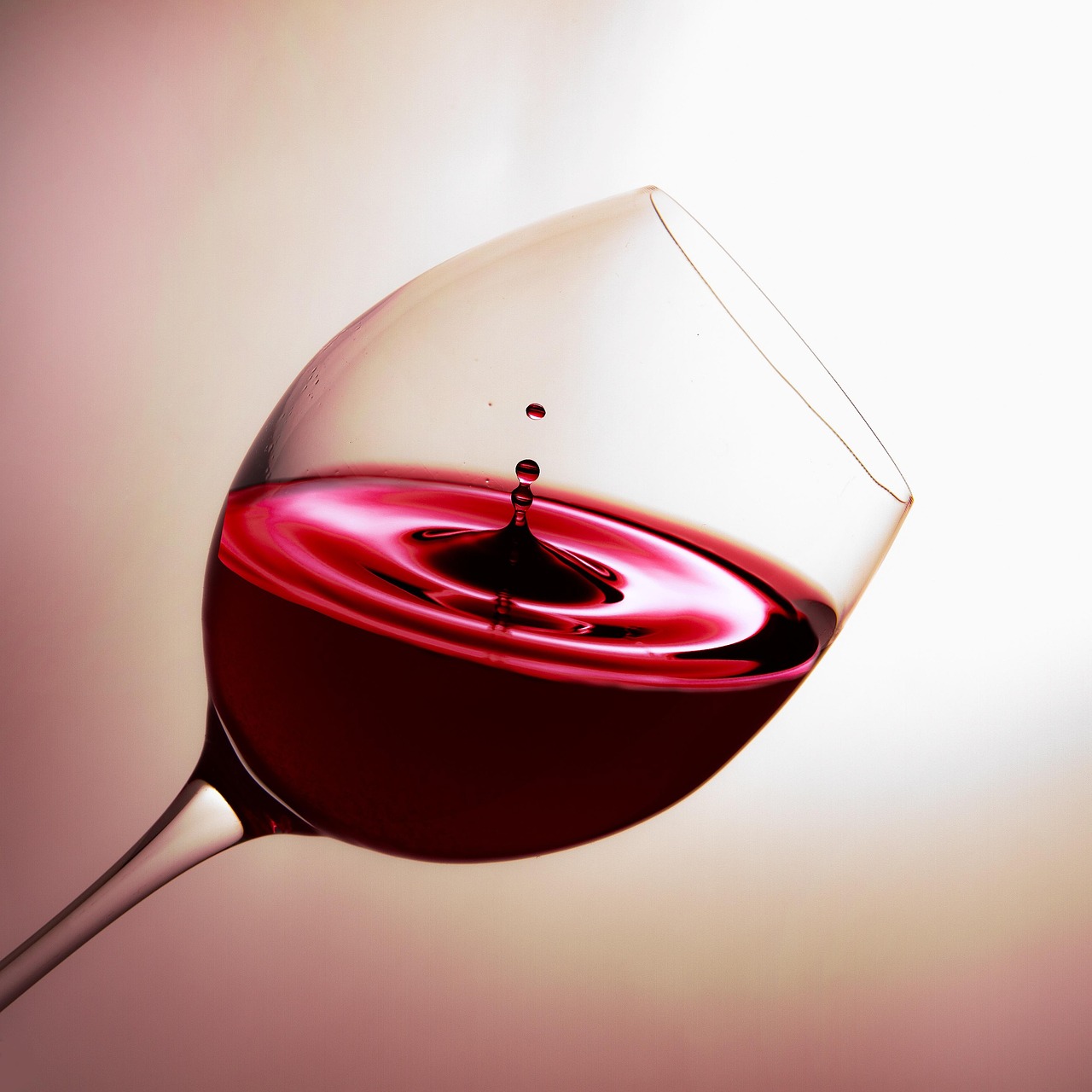 A glass of red wine and a glass of white wine side by side on a table